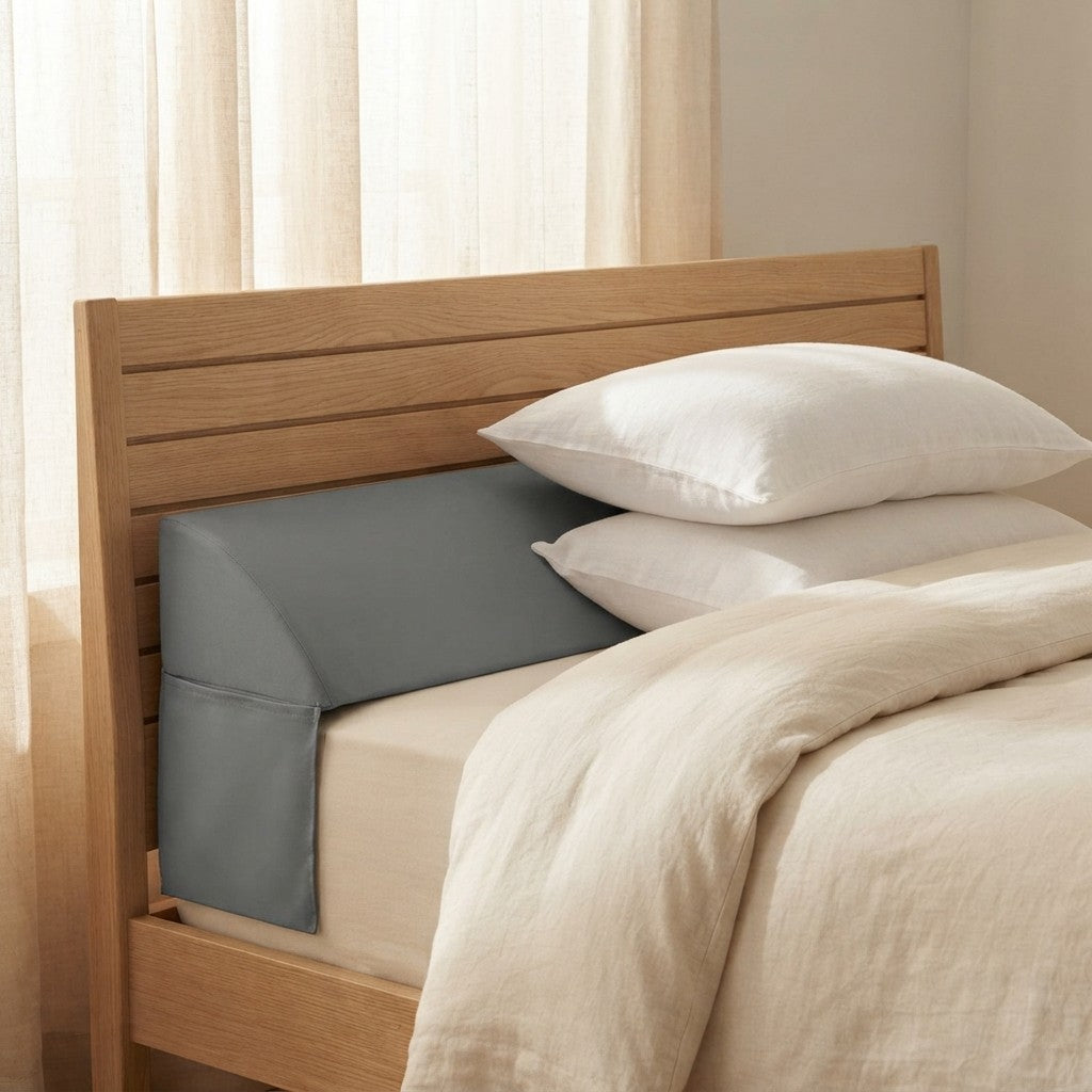 A grey bed gap pillow filling the space between headboard and mattress